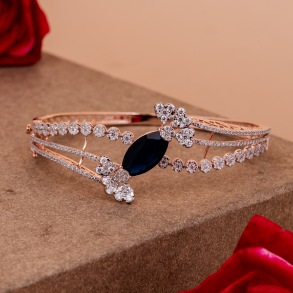 Elegant bangle with sapphire centerpiece and clustered crystal detailing