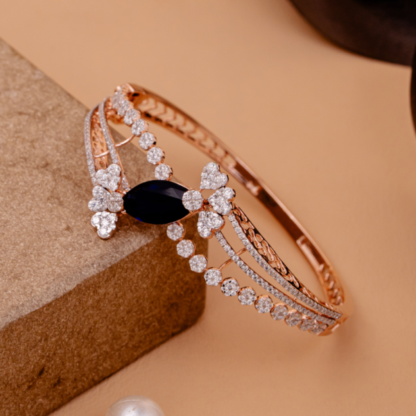 Elegant bangle with sapphire centerpiece and clustered crystal detailing