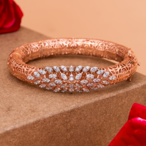 Lunaria Filigree Grace Bangle with intricate floral lattice and petal design on beige background.