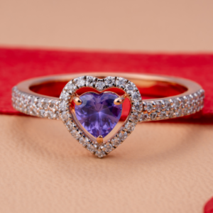 Elegant rose gold heart-shaped ring featuring a violet gemstone center surrounded by sparkling white stones, symbolizing love and elegance