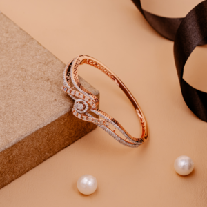 Elegant rose gold bangle featuring swirl patterns encrusted with baguette and round diamonds, symbolizing radiant movement and sophistication