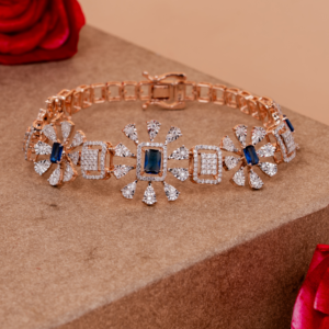 Elegant rose gold bracelet with sapphire-centered floral motifs and diamond accents for a royal touch